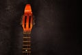 Neck of a stringed instrument mandolin on a dark background with copy space for your text