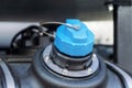 Neck of tank with a blue cap.Aqueous urea solution liquid - for injection into truck exhaust car system.