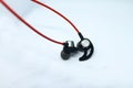 Neckband image. Bluetooth headset image. Red wired bluetooth earphones