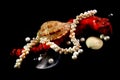 Necklace, coral, pearls and shells on a black background Royalty Free Stock Photo