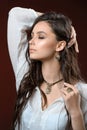 Necklace and earring on young woman. Beautiful model with perfect long hair Royalty Free Stock Photo