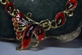 Necklace and earrings are gold and painted in red. To add beauty Designed Charming,