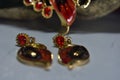 Necklace and earrings are gold and painted in red. To add beauty Designed Charming,