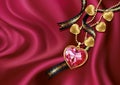 Necklace heart on red silk.