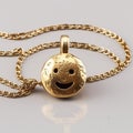 A necklace 24k gold with a round smiley face generative AI Royalty Free Stock Photo
