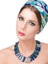 Necklace on the neck and hair with a headscarf. Beauty portrait of beautiful young woman Royalty Free Stock Photo