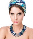 Necklace on the neck and hair with a headscarf. Beauty portrait Royalty Free Stock Photo