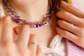 Amethys necklace with silver chain. An elegant woman. Selective focus