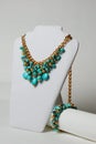 Necklace with turquoise, natural gemstones and gold chain on a mannequin Royalty Free Stock Photo