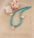 Necklace with turquoise semi precious stones and shells - summer jewelry advertisement Royalty Free Stock Photo