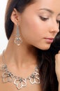 Necklace on woman`s neck and stylish earring on white background Royalty Free Stock Photo