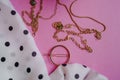 necklaces white dotted scarf and golden hairpin on pink