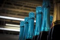 Necks of champagne bottles in foil on shelf. Vignette.