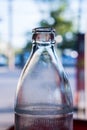 A necks of clear glass bottles in the sunlight