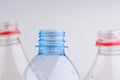 Necks of plastic bottles on a white background