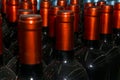 Necks of wine bottles with bright red foil closeup Royalty Free Stock Photo