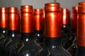 Necks of wine bottles with bright red foil closeup