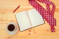 Necktie, diary, cup of coffee and pen on wooden table Royalty Free Stock Photo