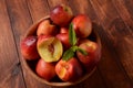 Nectarine. Ripe juicy organic nectarines in a wooden bowl.