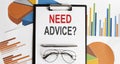 NEED ADVICE text . Conceptual background with chart ,papers, pen and glasses, business Royalty Free Stock Photo