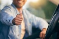 Need a cab I know a guy. an unrecognisable man showing thumbs up while traveling in a car. Royalty Free Stock Photo