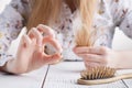 Need more vitamins, Woman with hair problems, lost hair on comb Royalty Free Stock Photo