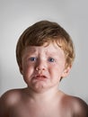 In need of some comforting. Upset red-headed toddler getting ready to cry.