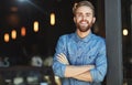 Need some great coffee Come on in. Portrait of a happy young man in a cafe. Royalty Free Stock Photo