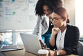 We need to be careful about our next business move. two businesswomen working together on a laptop in an office. Royalty Free Stock Photo