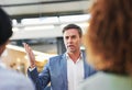 We need to be on the same page. a serious looking manager talking to his staff in an office. Royalty Free Stock Photo