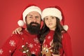 Need to cheer up. small girl and dad santa hat. daddy and kid red background. christmas time. new year party. happy to