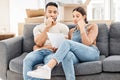 We need to make a plan about this. a young couple looking worried and reading a letter while moving house. Royalty Free Stock Photo