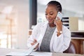 We need to reschedule our appointment. a young female doctor making a phone call using her smartphone.