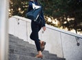 The need to succeed keeps her moving. a young businesswoman walking up stairs in the city. Royalty Free Stock Photo