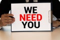 WE NEED YOU. message on the card shown by a man Royalty Free Stock Photo