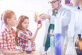 Smart schoolgirls participating in chemistry practical lesson Royalty Free Stock Photo