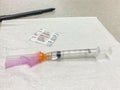 TORONTO, ONTARIO, CANADA - APRIL 20, 2021: NEEDLE WITH ASTRAZENECA VACCINE IN THE VILE