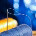 Needle and blue and yellow thread, shallow depth of field