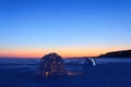 A snowy house called an igloo at sunset. Royalty Free Stock Photo