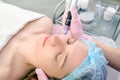 Needle mesotherapy. Cosmetologist performs needle mesotherapy on a womans face