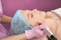 Needle mesotherapy. Cosmetologist performs needle mesotherapy on a womans face