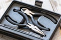 Needle nose pliers, wire cutter in plastic box Royalty Free Stock Photo