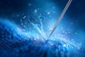 Needle pierces soft blue fabric, creating delicate threads with a magical glow. Vibrant textile setting ideal for Royalty Free Stock Photo