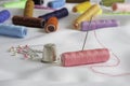 Needle, pins, thimble and colorful spools of thread Royalty Free Stock Photo