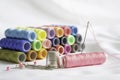 Needle, pins, thimble and colorful spools of thread Royalty Free Stock Photo