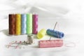 Needle, pins, thimble and colorful spools of thread Royalty Free Stock Photo