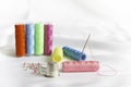 Needle, pins, thimble and colorful spools of thread Royalty Free Stock Photo