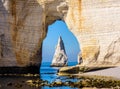 The Needle seen through the arch of the Manneporte cliff in Etretat, Normandy. Royalty Free Stock Photo