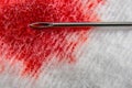 Needle syringe on cotton surface with blood is macro