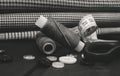 A needle with thread, buttons and scissors lie on a wooden background. Black and white photo Royalty Free Stock Photo